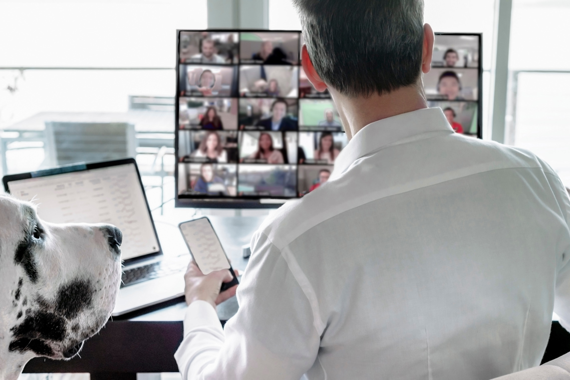 Man at computer in a meeting from home