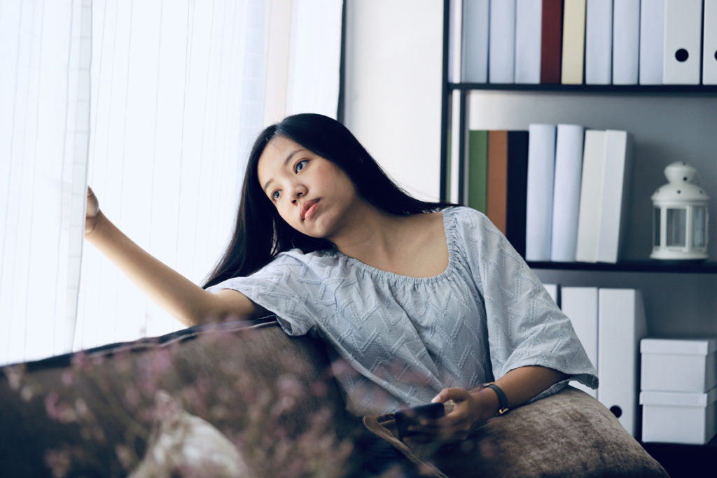 Woman sitting by window