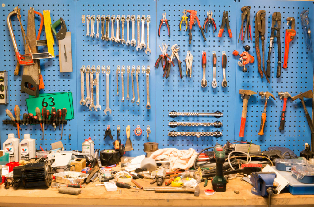 Tools on bench and hanging on wall